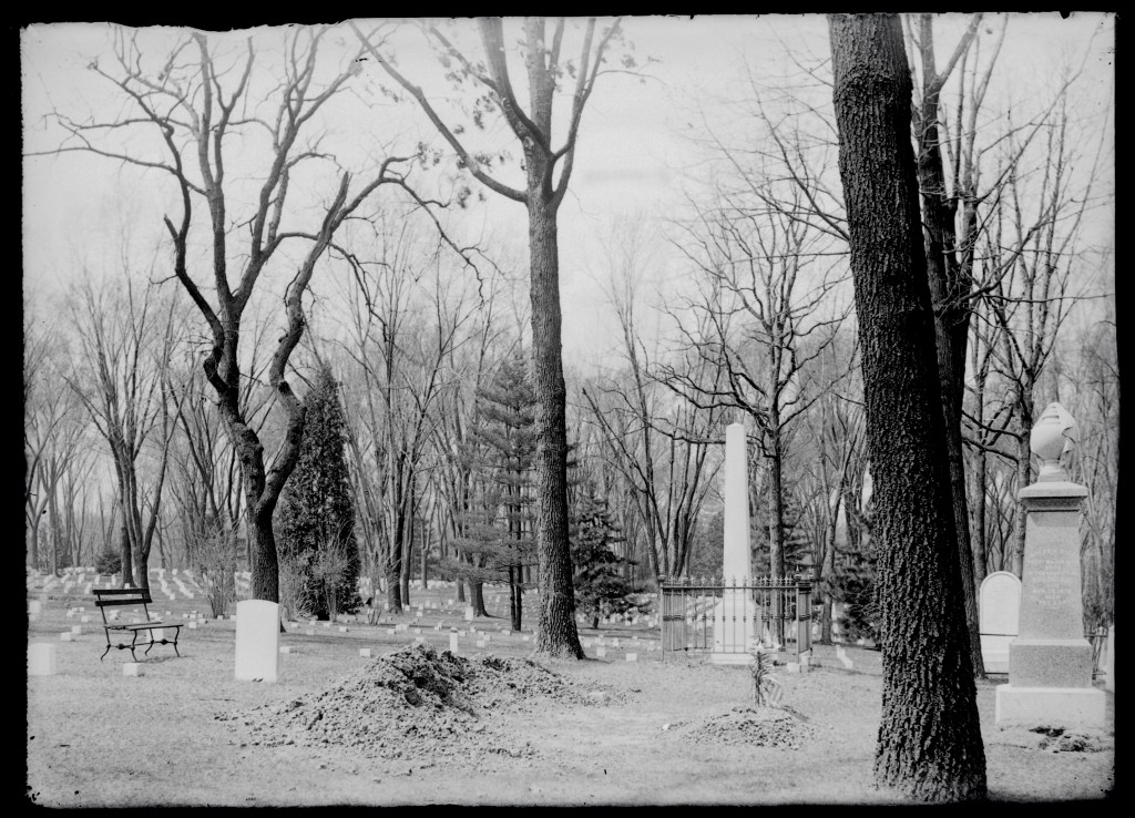 Black-and-white photograph of Jefferson Barracks National Cemetery around 1900, showing rows of grave markers among mature trees.